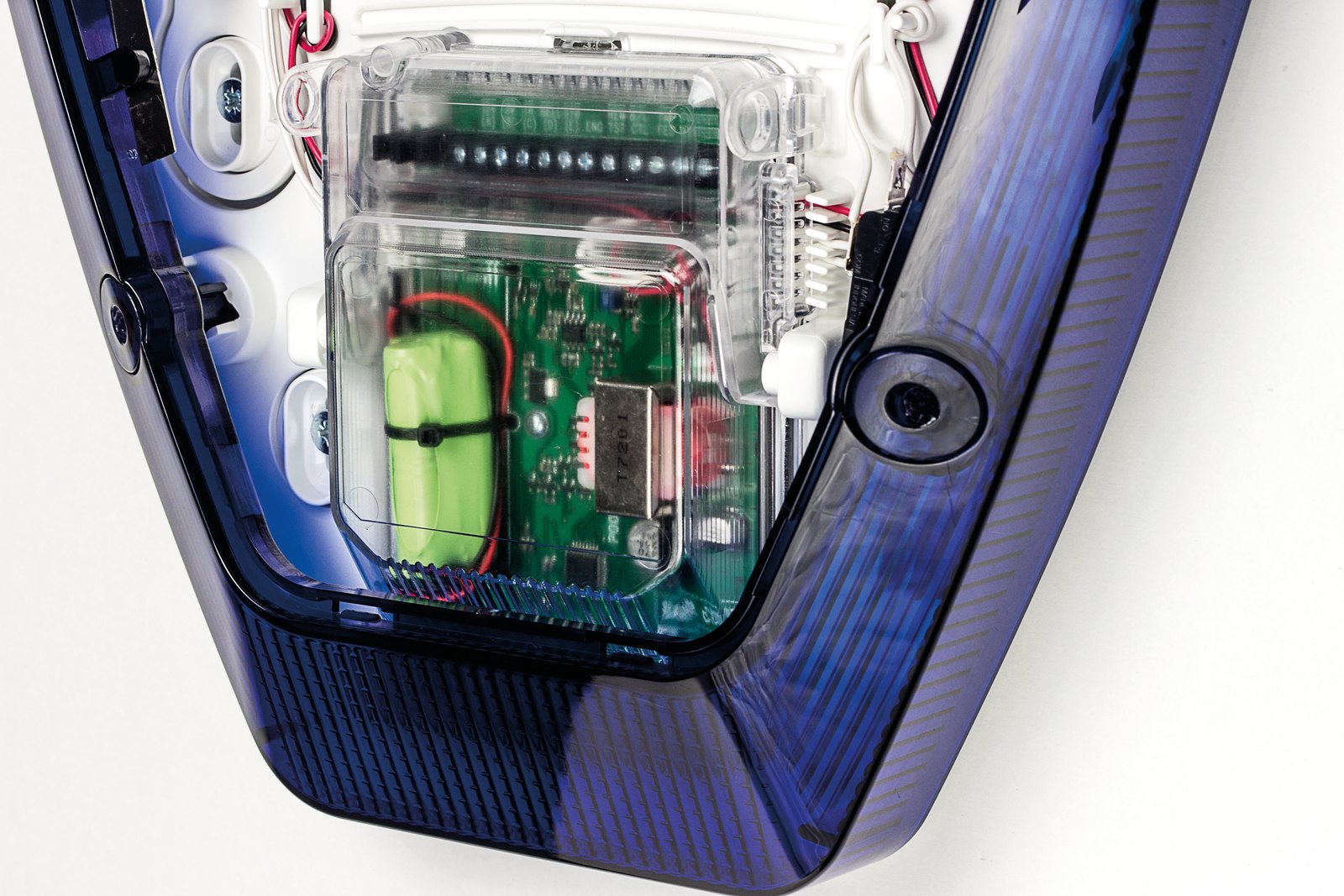 Orisec alarm bell box with its cover open, showing the circuit board and backup battery