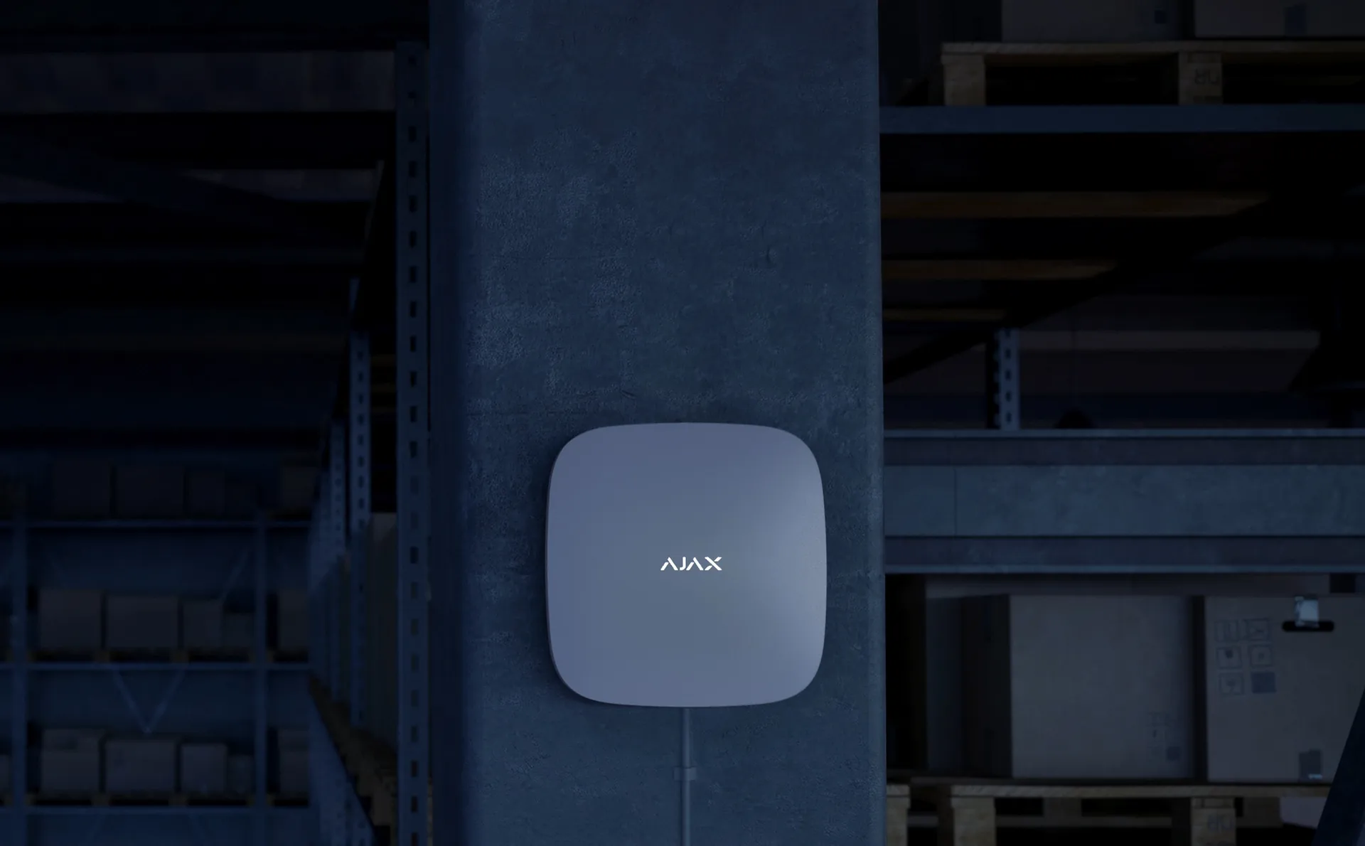 Ajax Hub 2 alarm control panel mounted on a pillar in a warehouse
