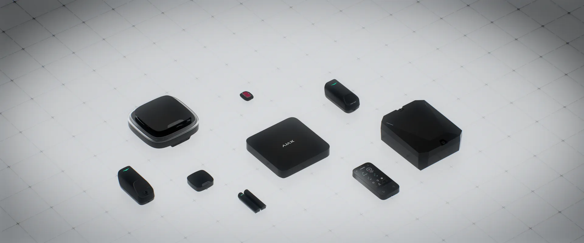 Ajax hub, keypad, siren, detectors and key fob laid out together