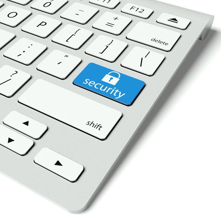 Computer keyboard with a blue security key marked with a padlock