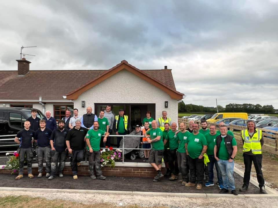 The Band of Builders project team outside the completed home adaptation
